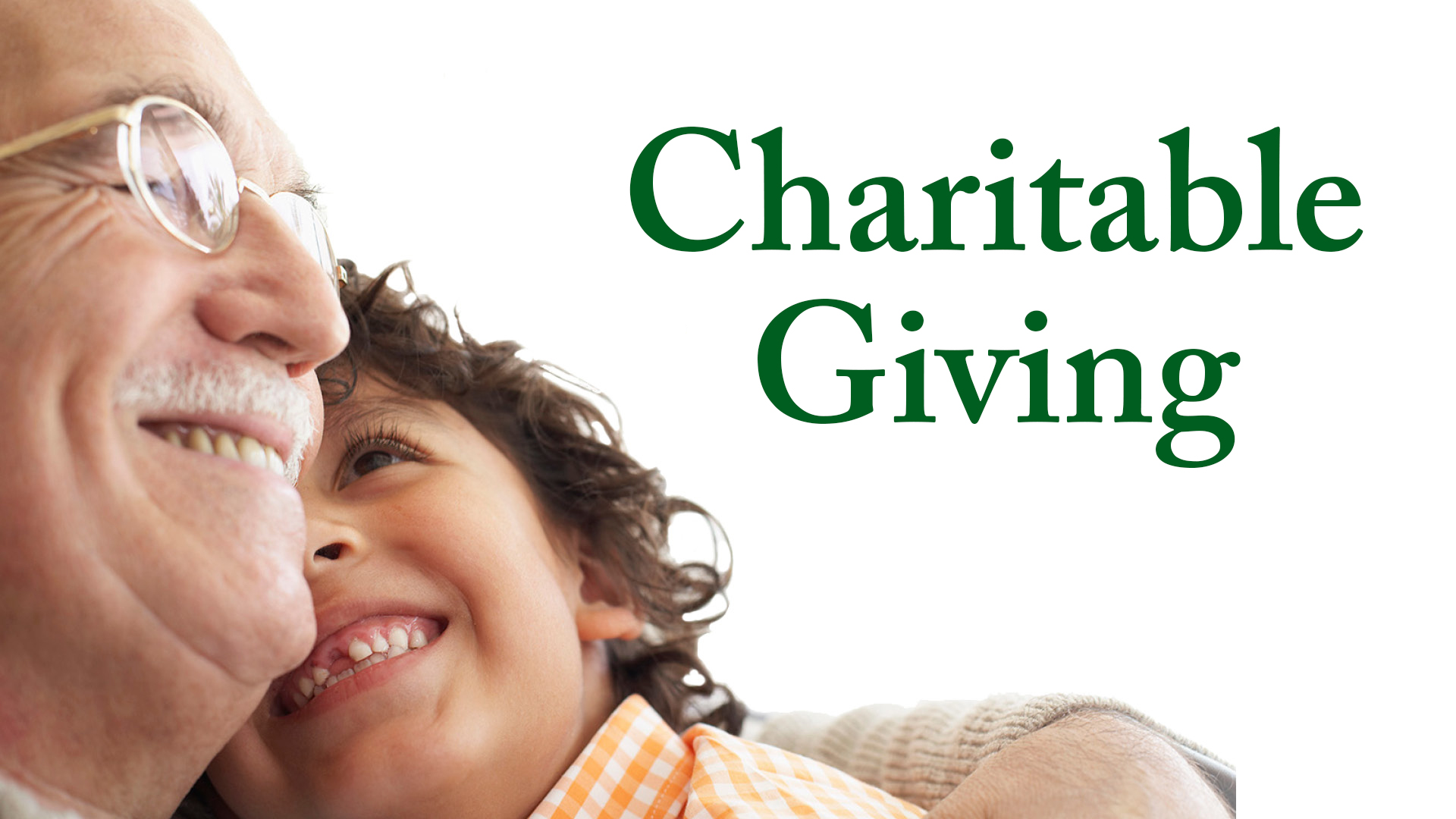 Older and younger males smiling at each other with the text "Charitable Giving" beside them
