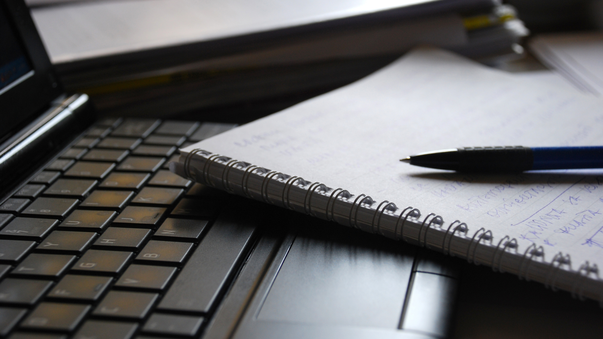 Close up of notepad on corner of a laptop.