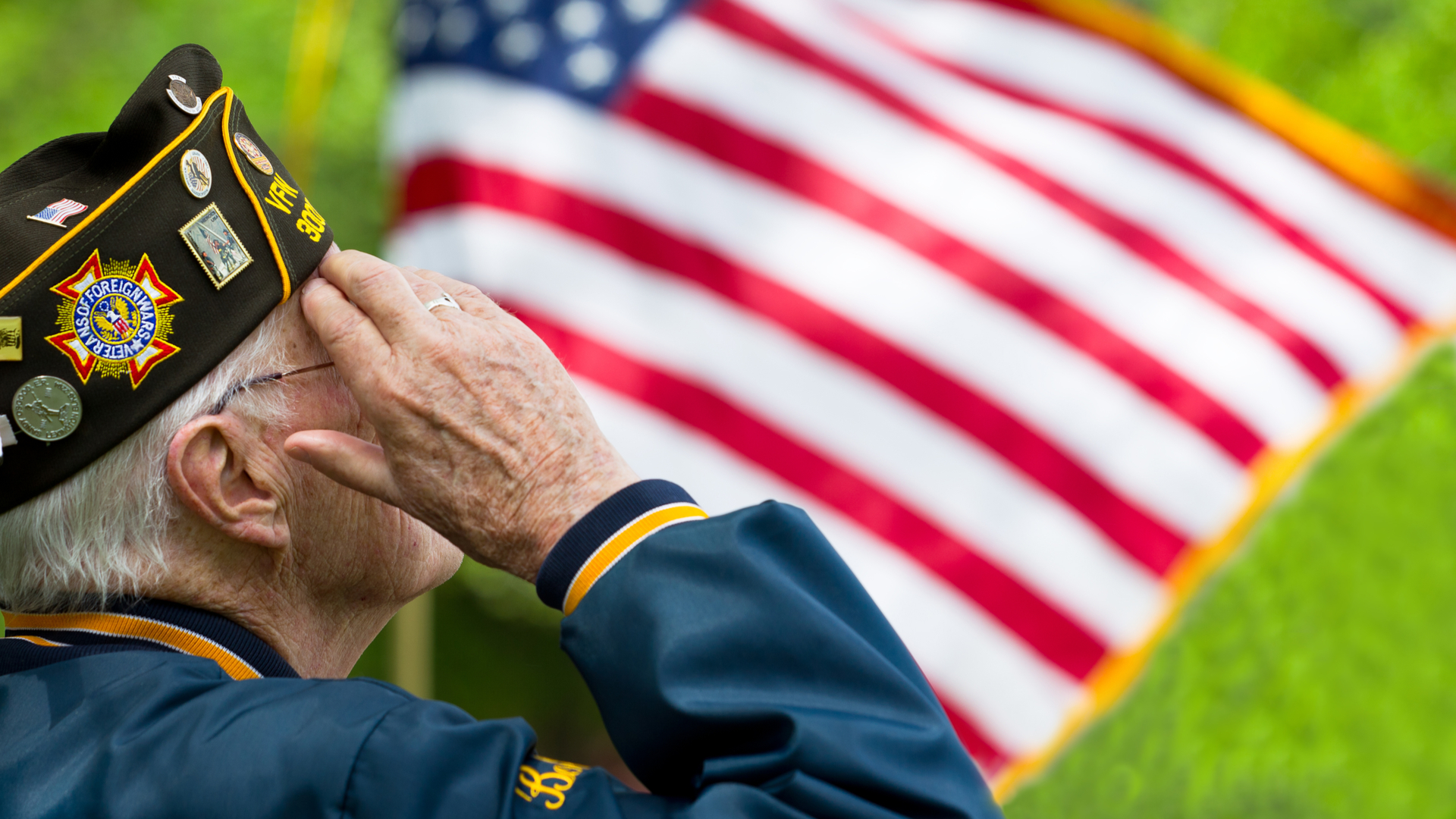 Photo of veteran saluting US flag